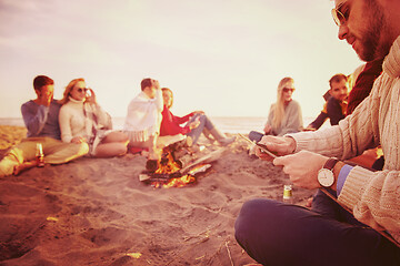 Image showing Friends having fun at beach on autumn day