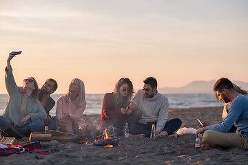 Image showing Friends having fun at beach on autumn day