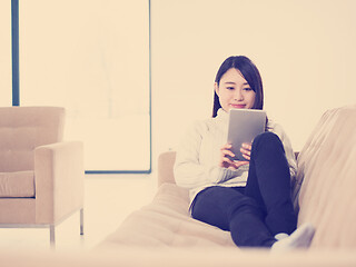 Image showing asian woman using Digital Tablet on sofa