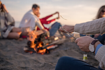 Image showing Friends having fun at beach on autumn day