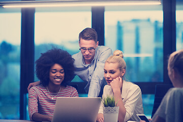 Image showing Multiethnic startup business team in night office