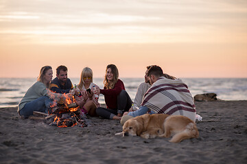 Image showing Friends having fun at beach on autumn day