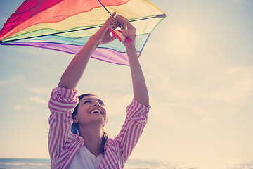 Image showing Young Woman with kite at beach on autumn day