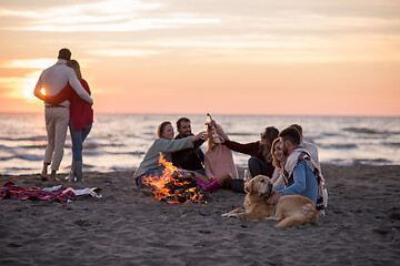 Image showing Couple enjoying with friends at sunset on the beach