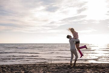 Image showing Loving young couple on a beach at autumn sunny day