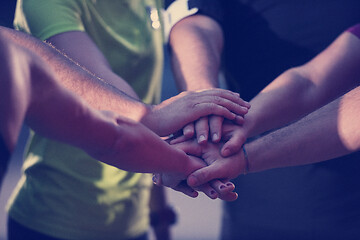 Image showing runners giving high five to each other