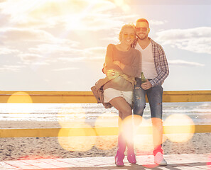 Image showing young couple drinking beer together at the beach