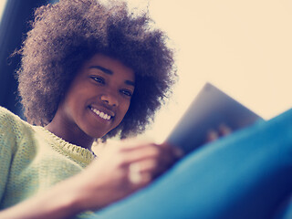 Image showing young african american woman at home using digital tablet