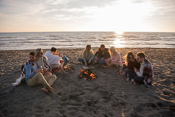 Image showing Friends having fun at beach on autumn day