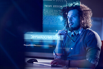 Image showing man working on computer in dark office