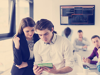 Image showing Two Business People Working With Tablet in office