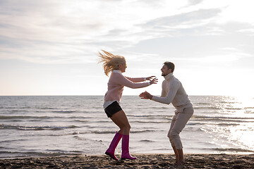 Image showing Loving young couple on a beach at autumn sunny day