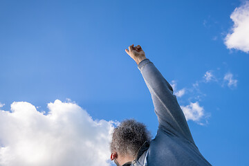 Image showing bearded man pointing up to the blue sky