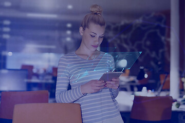 Image showing woman working on digital tablet in night office