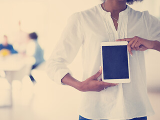 Image showing Portrait of  black casual businesswoman using tablet  with cowor