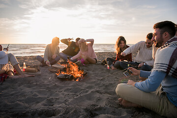 Image showing Friends having fun at beach on autumn day