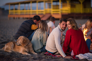 Image showing Couple enjoying with friends at sunset on the beach