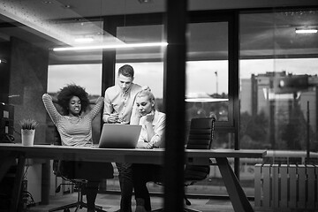 Image showing Multiethnic startup business team in night office