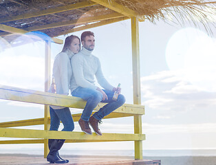 Image showing young couple drinking beer together at the beach