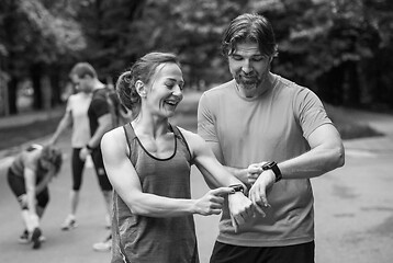 Image showing sporty couple using smart watches