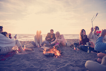 Image showing Friends having fun at beach on autumn day