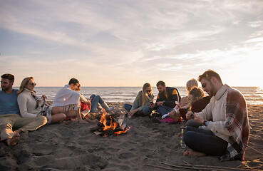 Image showing Friends having fun at beach on autumn day