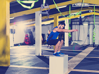 Image showing man working out jumping on fit box