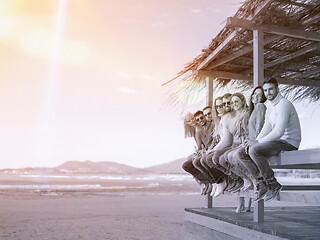 Image showing Group of friends having fun on autumn day at beach