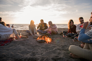 Image showing Friends having fun at beach on autumn day