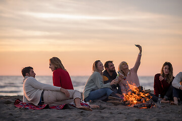 Image showing Friends having fun at beach on autumn day