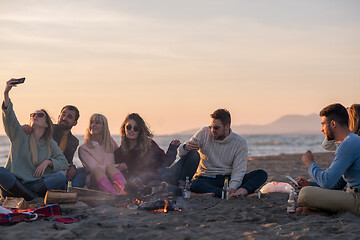 Image showing Friends having fun at beach on autumn day