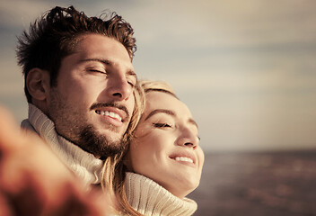 Image showing Loving young couple on a beach at autumn sunny day