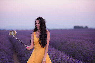 Image showing woman in lavender field taking selfie