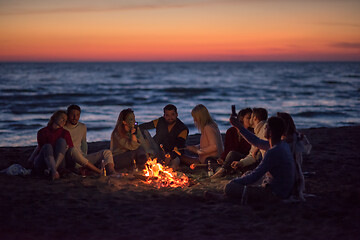 Image showing a group of friends enjoying bonfire on beach