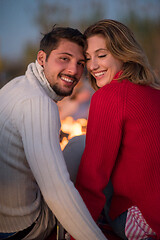 Image showing Couple enjoying with friends at sunset on the beach