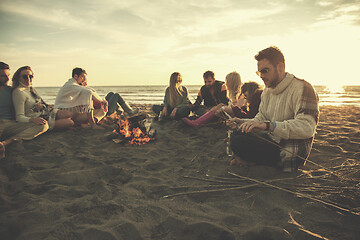 Image showing Friends having fun at beach on autumn day