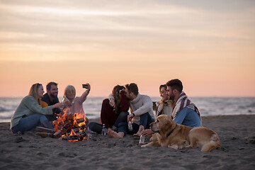 Image showing Friends having fun at beach on autumn day