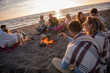 Image showing Friends having fun at beach on autumn day