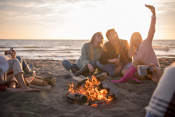 Image showing Friends having fun at beach on autumn day