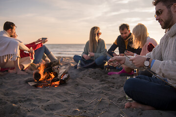 Image showing Friends having fun at beach on autumn day