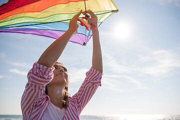 Image showing Young Woman with kite at beach on autumn day