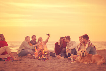 Image showing Friends having fun at beach on autumn day