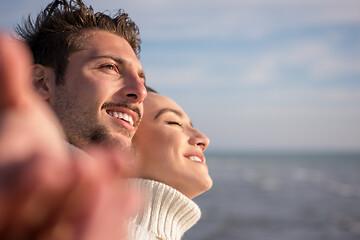 Image showing Loving young couple on a beach at autumn sunny day