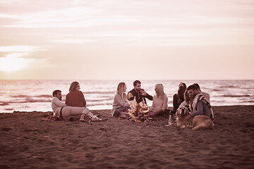 Image showing Friends having fun at beach on autumn day