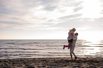 Image showing Loving young couple on a beach at autumn sunny day