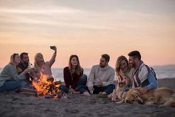 Image showing Friends having fun at beach on autumn day