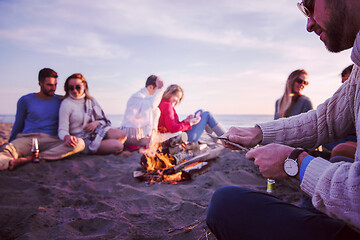 Image showing Friends having fun at beach on autumn day