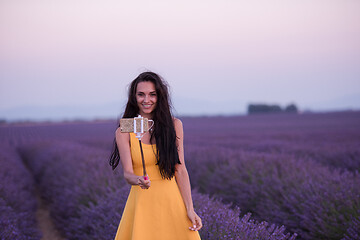 Image showing woman in lavender field taking selfie