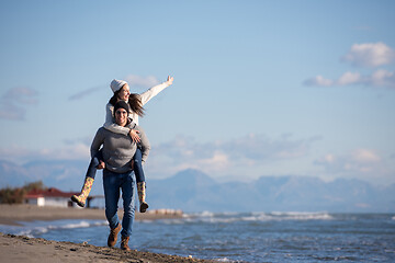 Image showing couple having fun at beach during autumn