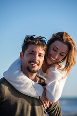 Image showing couple having fun at beach during autumn